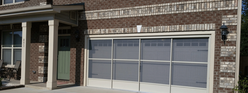 Sliding garage door screens installed in a house, providing a functional and stylish way to keep insects out